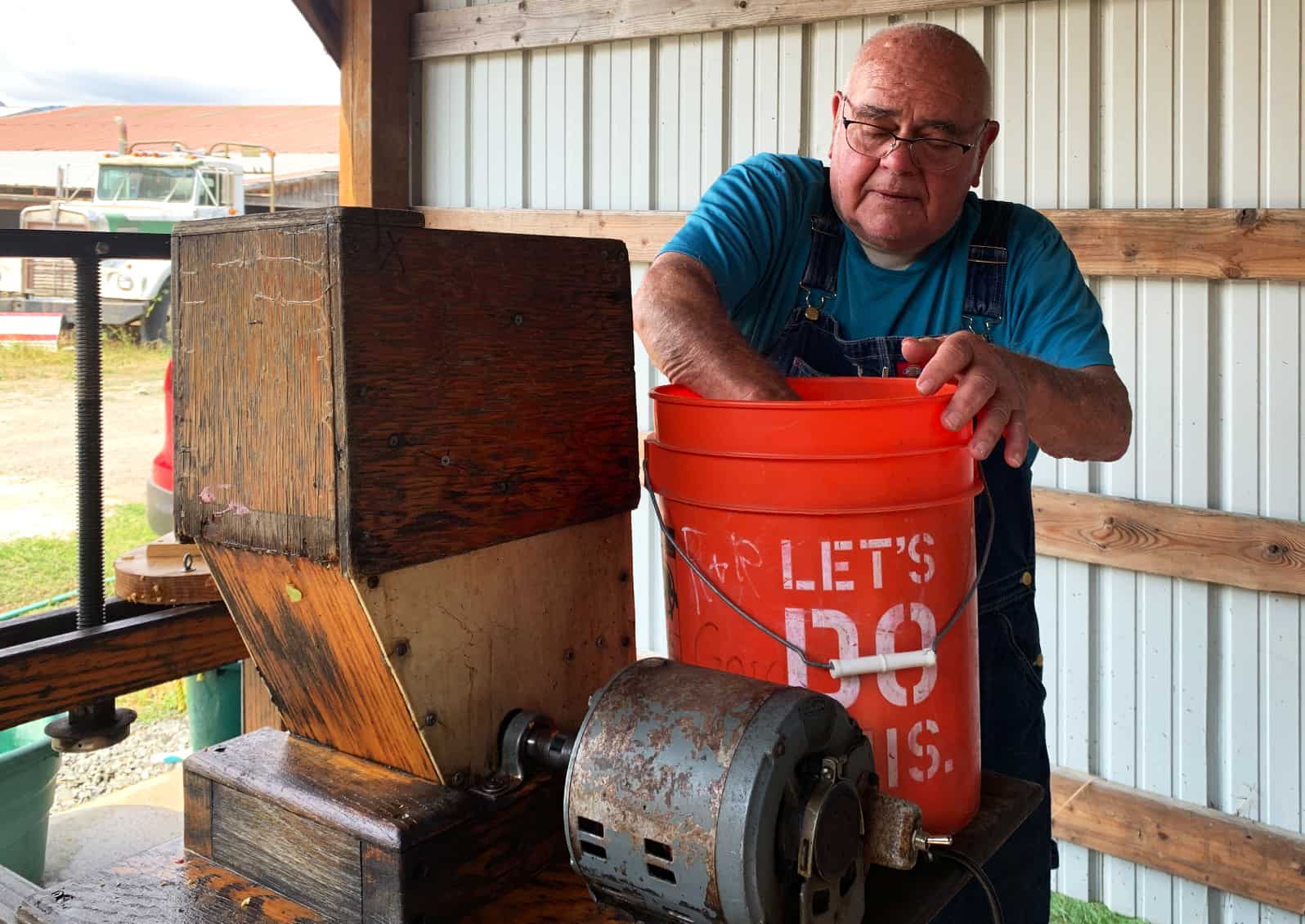 Toby bought his press Correll Cider Press with an electric drive mill more than 20 years ago. He and his friends press 100 gallons of sweet cider each year. © Ginny Bode