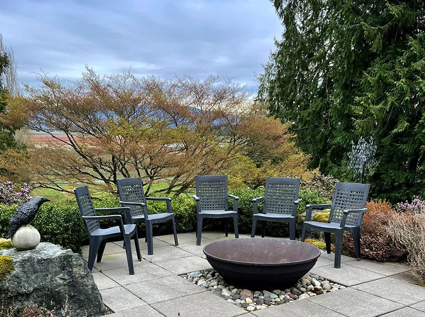 A firepit with a good-sized seating area and multiple fire irons to stoke the flames and share fond memories might be just the right idea. © Photographer: Kathy Wolfe