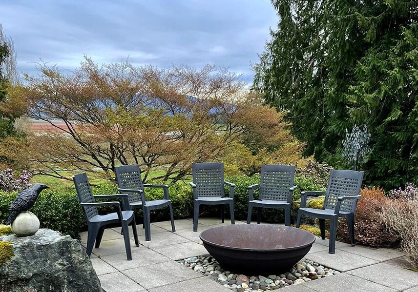 A firepit with a good-sized seating area and multiple fire irons to stoke the flames and share fond memories might be just the right idea. © Photographer: Kathy Wolfe