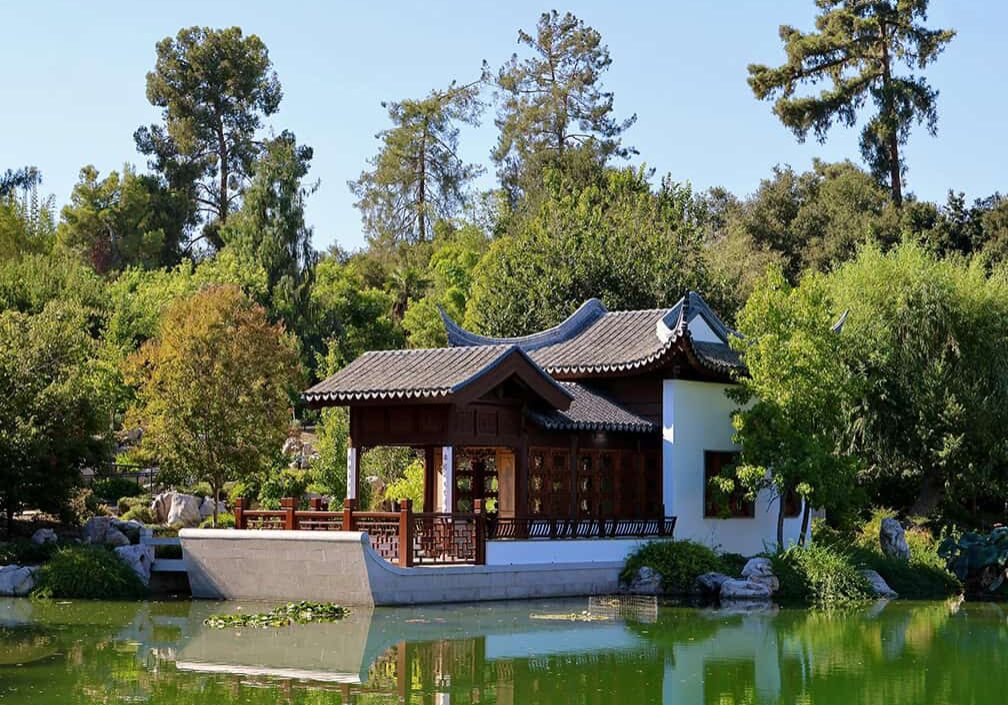 Chinese building beside pond in large garden